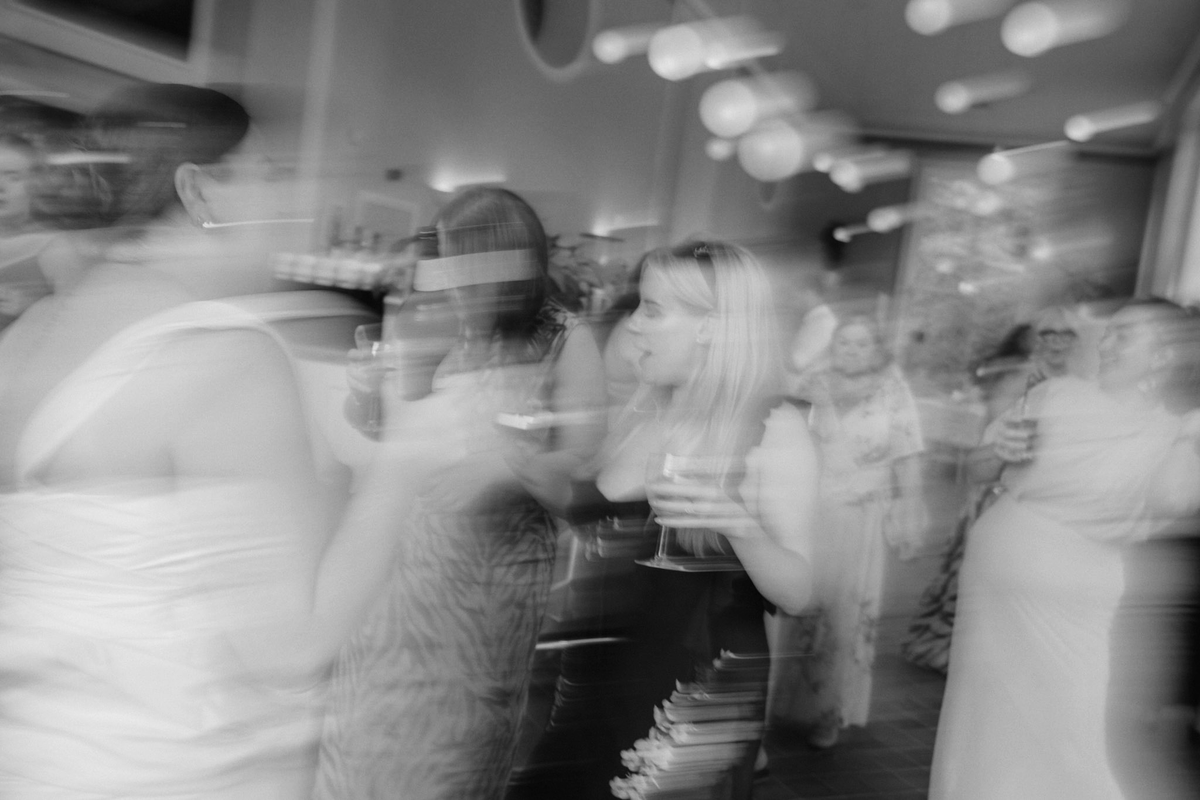 Candid unfiltered wedding reception footage captured on a vintage camcorder, guests celebrating at a real UK wedding.