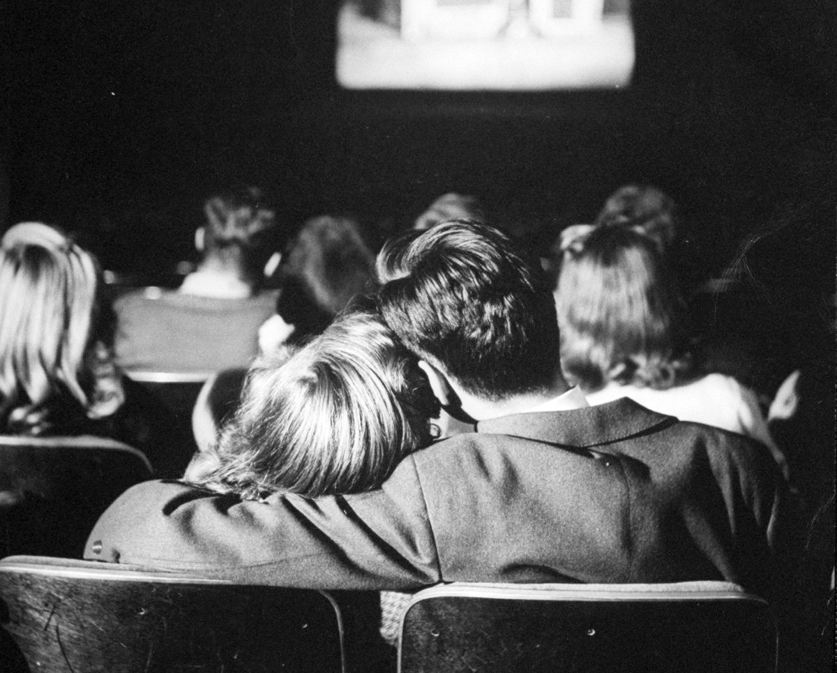 Couple watching back their wedding camcorder footage together, reliving real unfiltered memories from their wedding day.