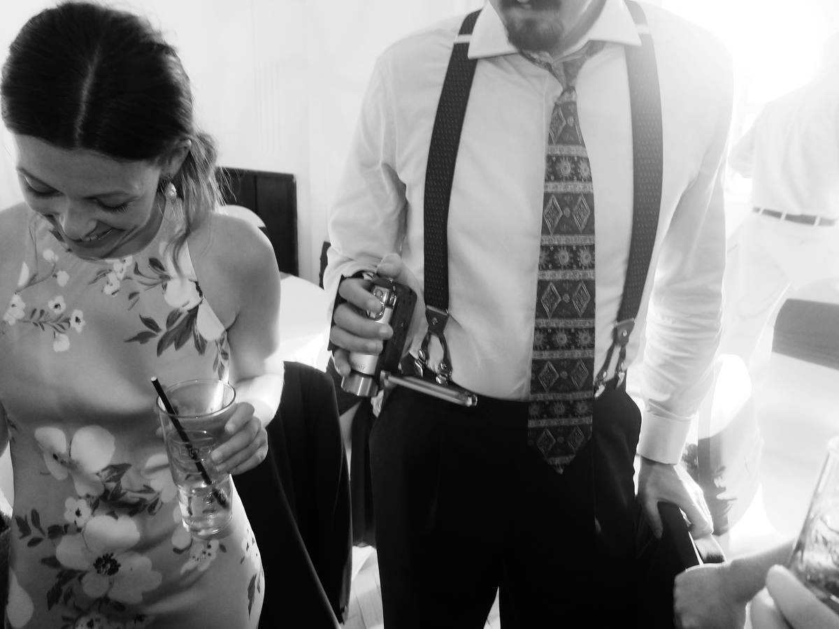 Wedding guests at a real UK wedding captured on a vintage camcorder, candid unfiltered moments as an alternative wedding video idea.