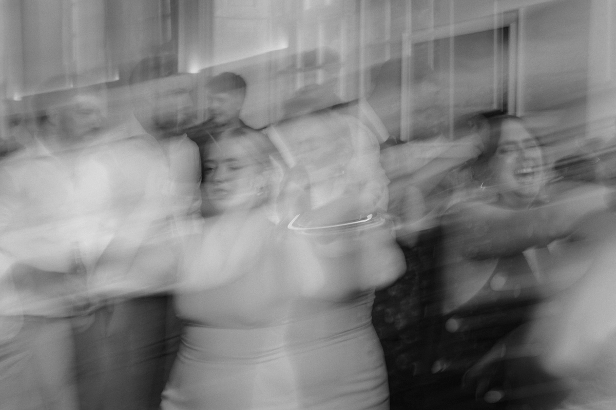 Wedding guests dancing and celebrating captured on a vintage camcorder, raw unfiltered wedding footage from a real UK wedding.